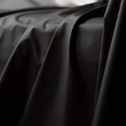 Black Fluid proof sex sheet draped over a sofa