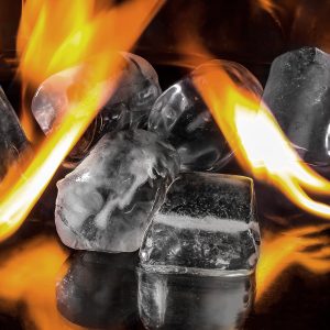Image of ice cubes and orange flames against a dark background to illustrate a blog on Temperature play