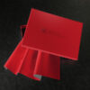 Red Sheets of San Francisco Branded box slightly open with a pleated sample of red fabric showing