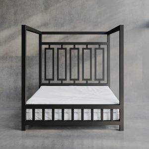 Product image of a White Sheets of San Francisco Waterproof, lube proof and fluidproof bed sheet designed to protect the mattress from and mess and fluids during sex. Displayed on a black metal four poster dungeon bed set against grey polished concrete floor and walls with full height glazing giving views of grass and shrubs in the garden