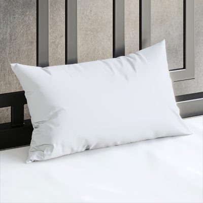 Close up of a Sheets of San Francisco White waterproof pillow case on a bed covered in a White Sheets of San Francisco fluid-proof fitted sheet and against a black metal bedhead with the polished concrete wall behind showing through.
