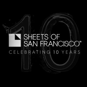 Silver/white Sheets of San Francisco logo on a black backdrop with Celebrating 10 years and a large water like figure 10